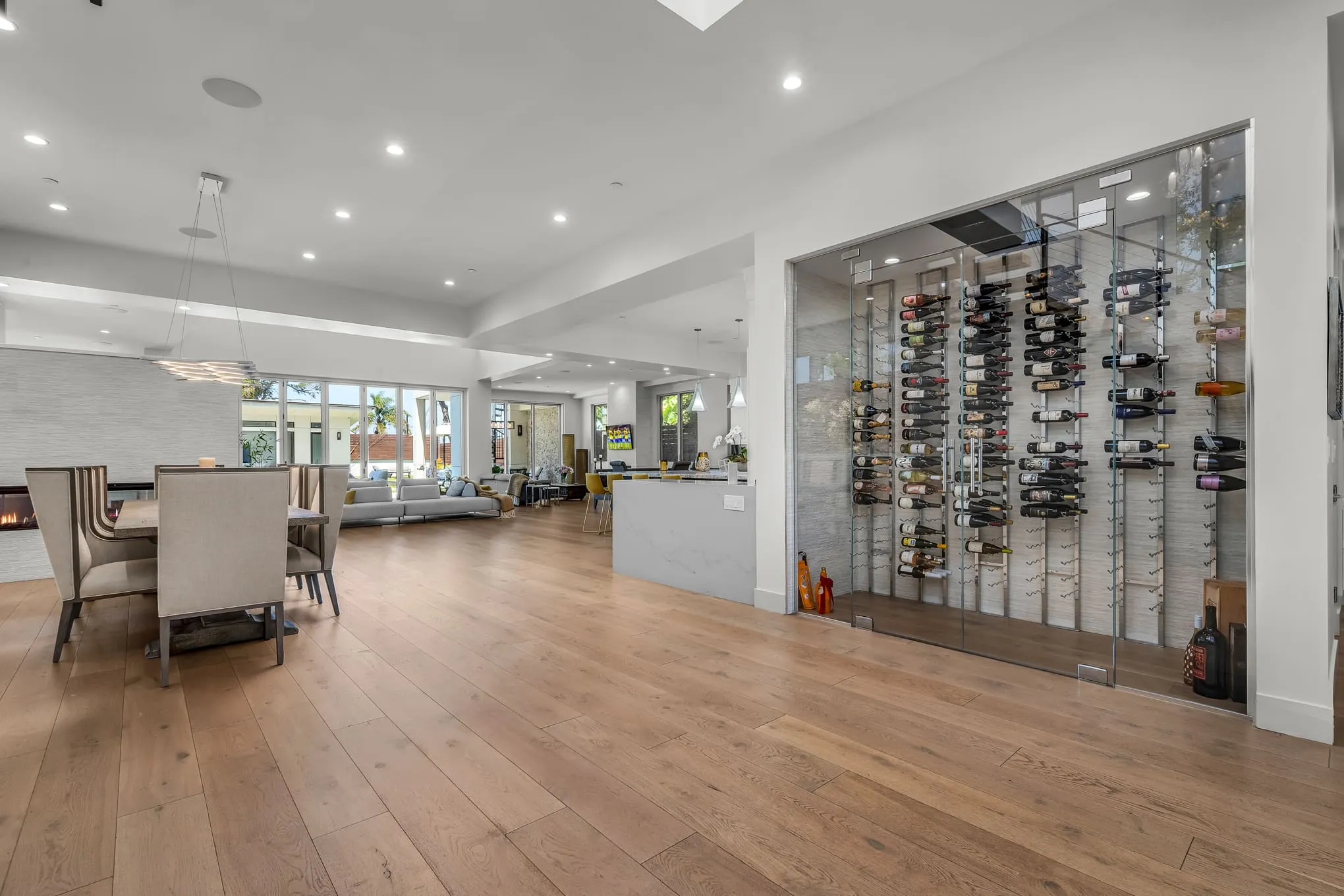Open-concept great room with the glass wine room